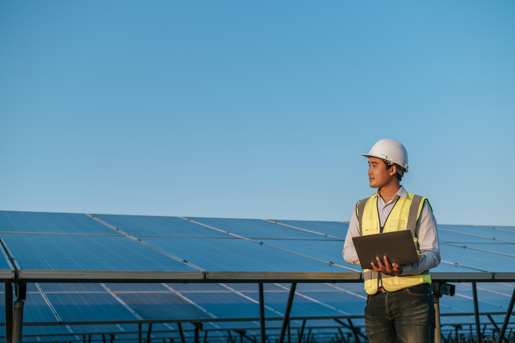 Engineer checking generation data at a solar farm